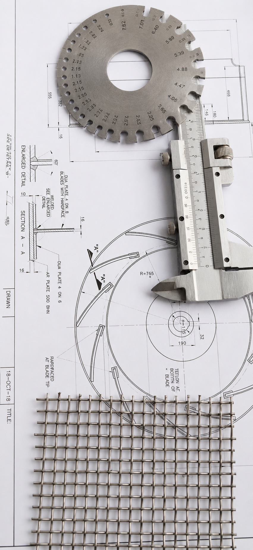 Inspection tools and a wire mesh sample on an engineering drawing